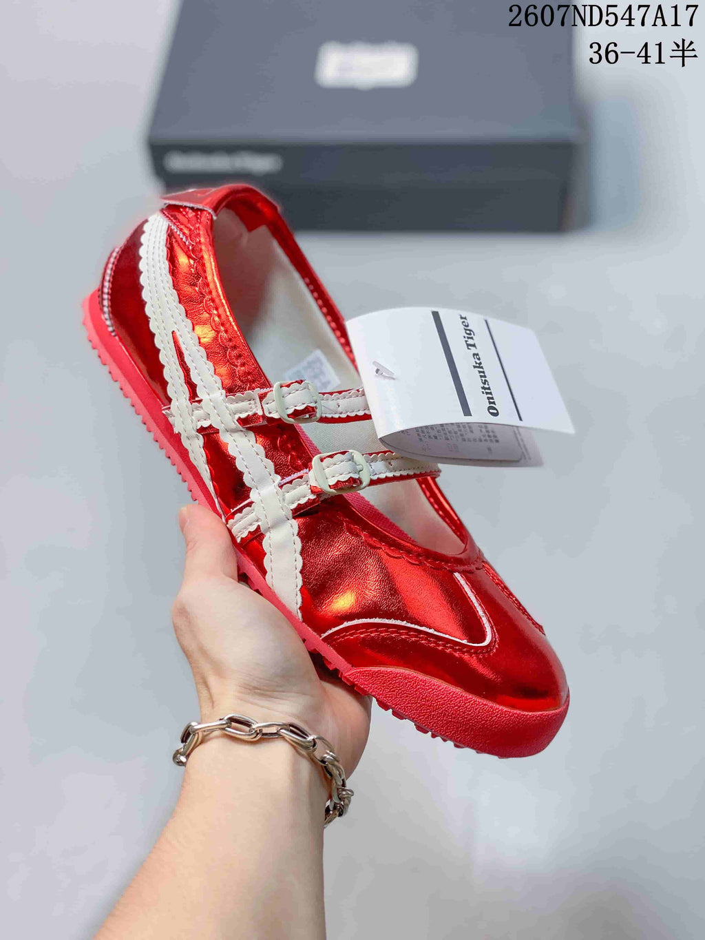 Bright red metallic Mary Jane sneaker with contrasting white straps and a red sole.