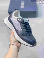 Navy and white Dior B25 Runner sneaker with a patterned side panel and sculpted outsole.