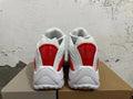 Rear view of white sneakers with red heel panels and chunky outsoles