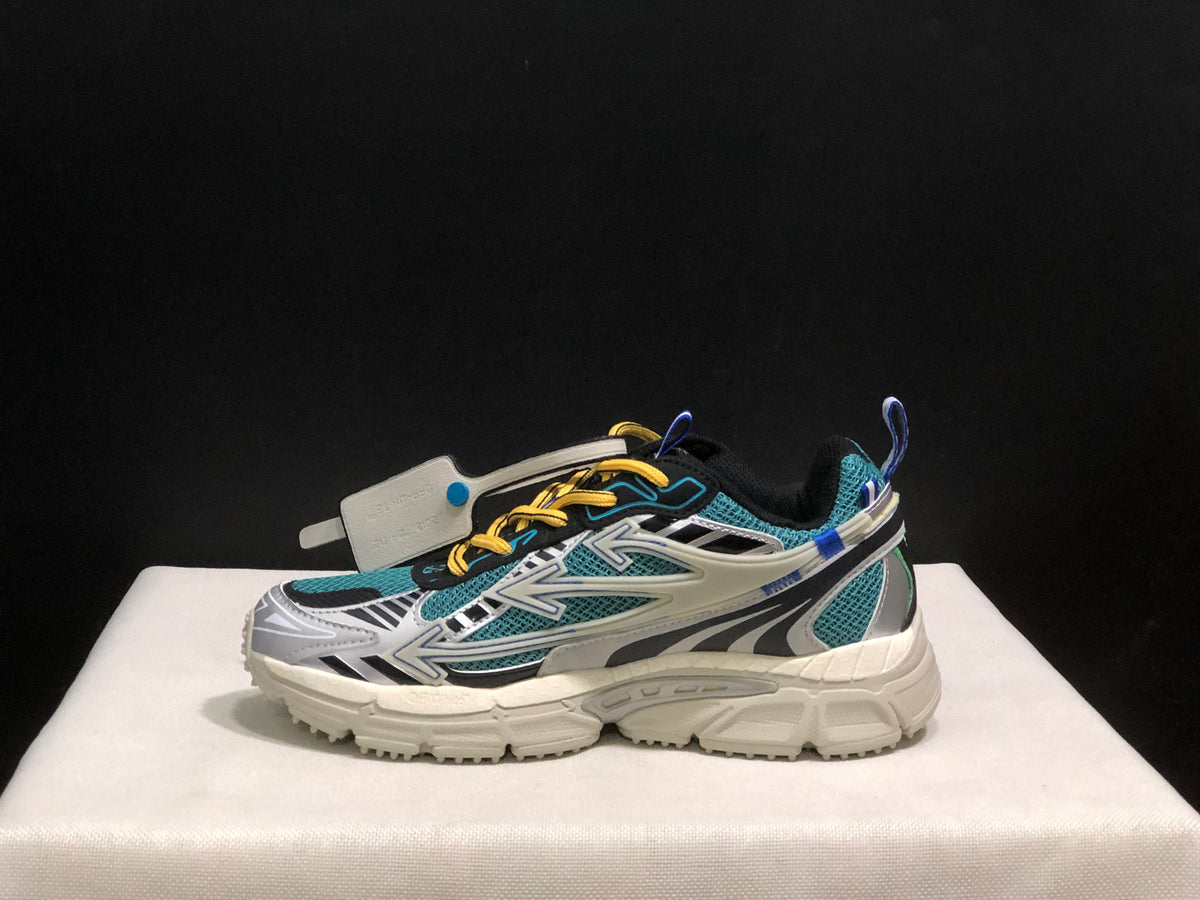 Profile view showing the teal mesh upper, graphic side overlays, lace system, and thick outsole.