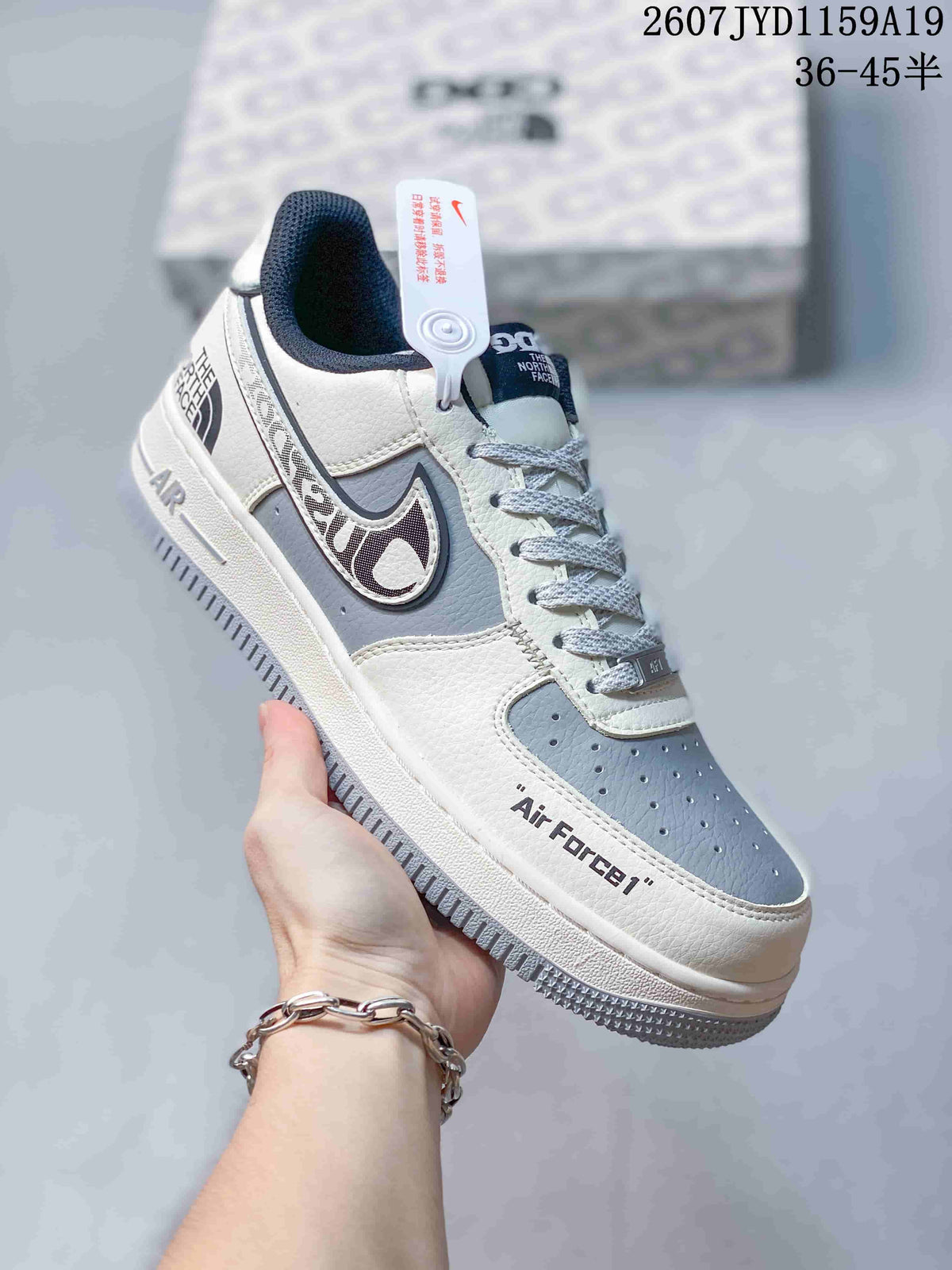 Angled side view highlighting the white and gray color blocking, side markings, low-top profile, and outsole.