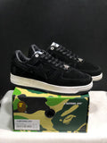 Pair of black BAPE STA low-top sneakers displayed on a camouflage presentation box; the box label shows US 8, UK 7, EU 41 and CM 26.