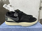 Side view of black Nike basketball shoes with a dark Swoosh and contrasting heel panel