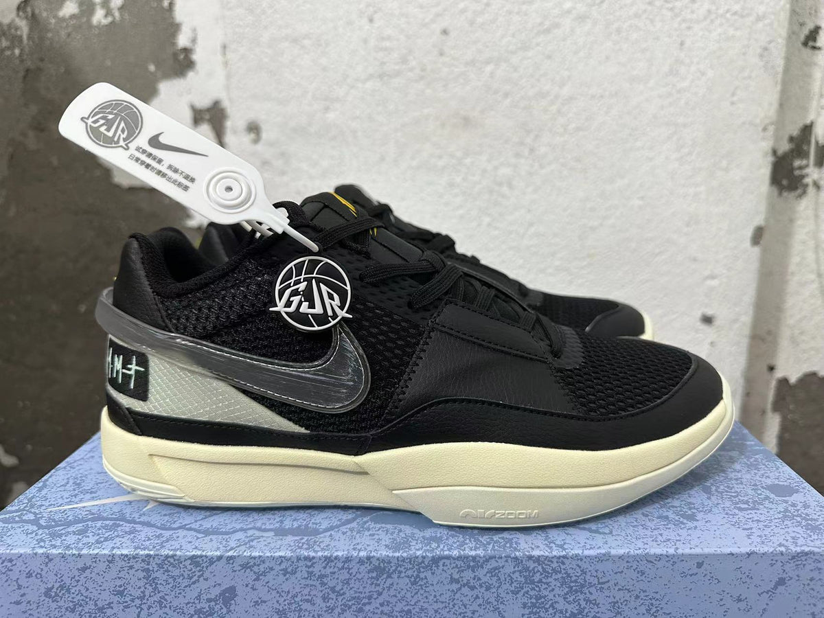 Side view of black Nike basketball shoes with a dark Swoosh and contrasting heel panel