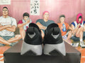 Rear view of black and grey Nike sneakers showing heel pull tabs and outsole details