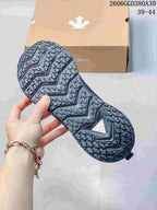 Close view of the patterned outsole on a dark gray training shoe
