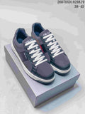 Navy Prada Downtown low-top sneakers with white laces and contrasting light-colored soles on a box; style code 2607HXD1829A19 and size range 38–45 are visible.