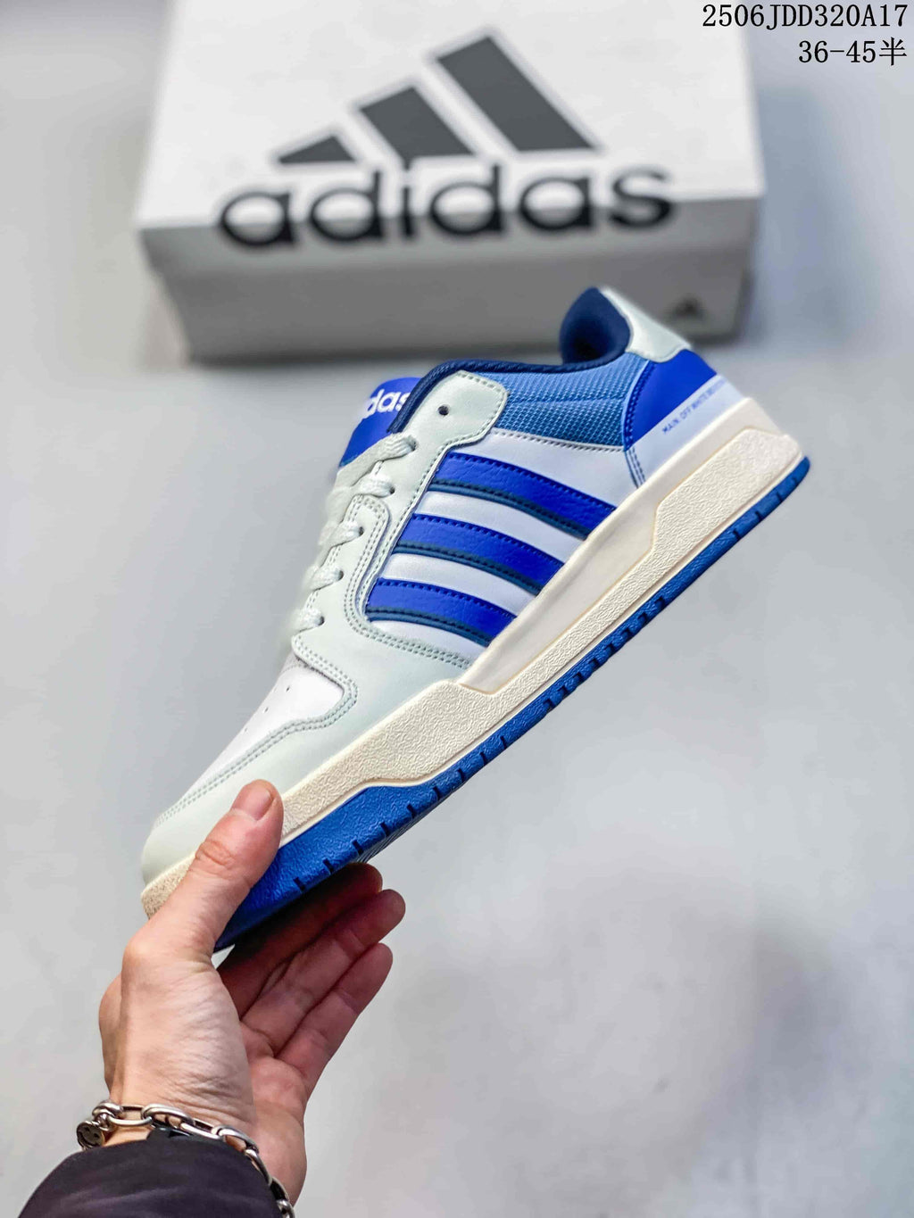 Side view of the adidas Entrap sneaker showing the blue three-stripe detail, white upper panels and blue outsole.