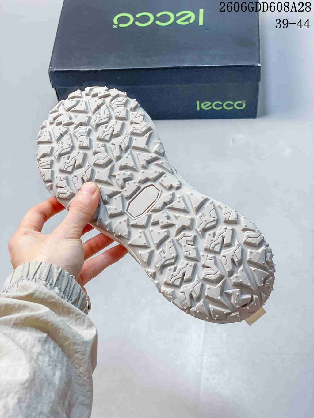 Close-up of the white sneaker's patterned outsole.