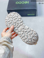 Close-up of the white sneaker's patterned outsole.
