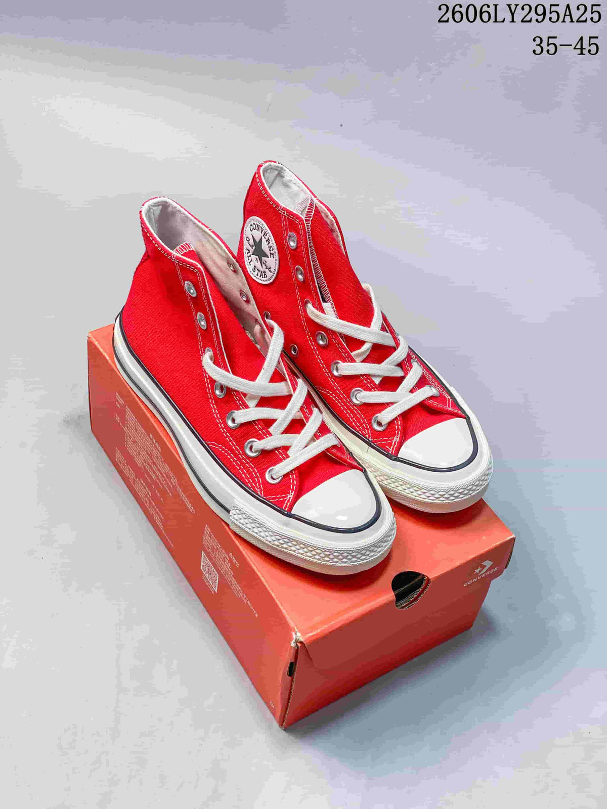 Pair of red Converse Chuck Taylor All Star high-top sneakers displayed on a Converse shoebox; style code 2606LY295A25 and size range 35–45 are visible.