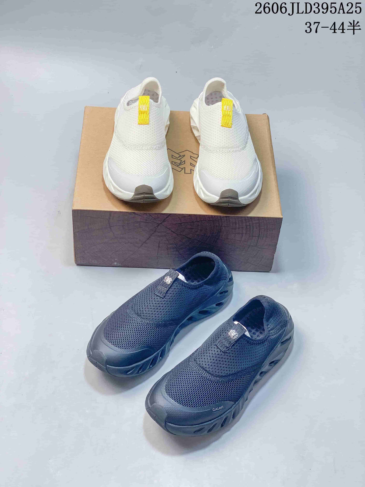 White and dark gray pairs of Galah slip-on shoes shown together.