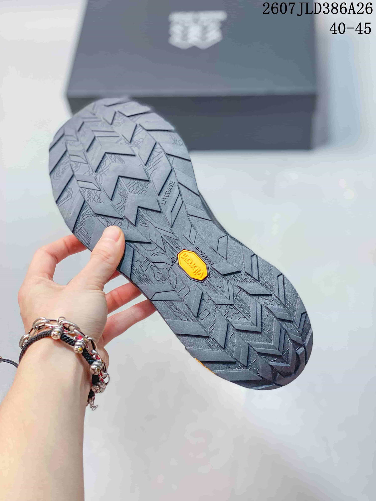 Close view of the hiking shoe outsole showing a deep directional tread pattern and a visible Vibram-branded insert.