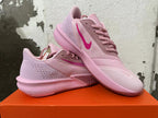 Pair of pink Nike Precision 7 basketball shoes shown from the side