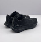 Rear three-quarter view of the black Alo sneakers showing the heel branding, padded collars, and raised outsole.