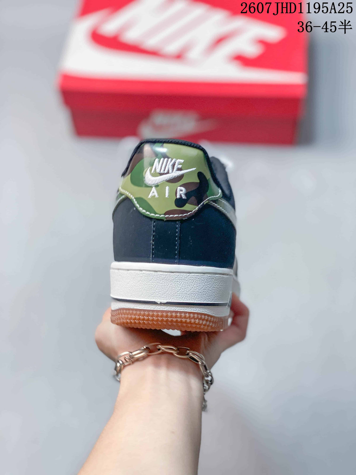 Rear view showing the navy heel, white midsole, gum outsole, and camouflage-patterned tongue detail.