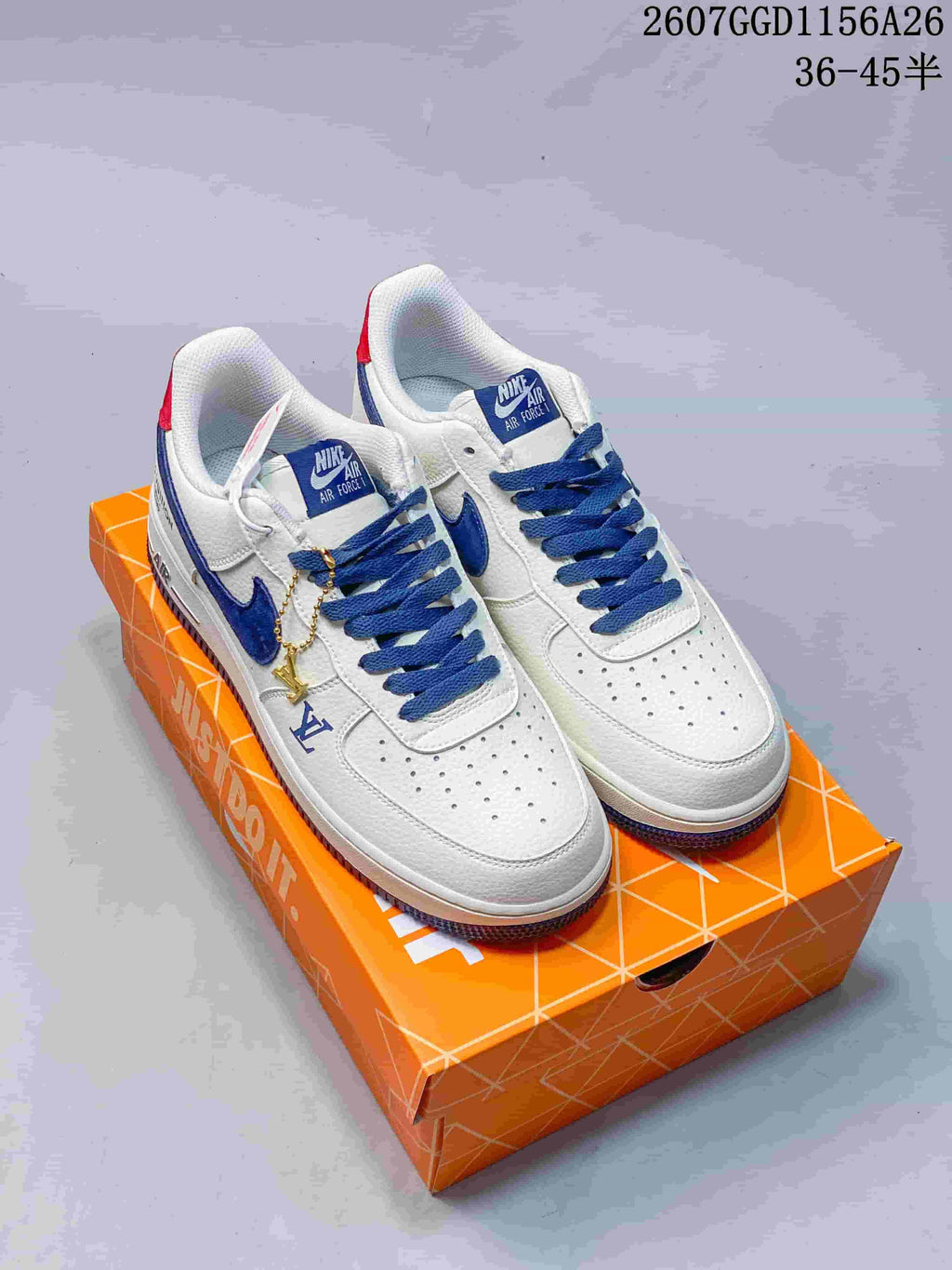 Pair of white and blue low-top sneakers displayed on an orange shoebox, with the style code and size range overlaid at the top.