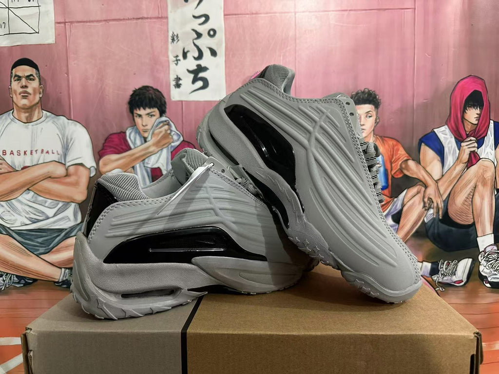 Pair of grey sneakers showing sculpted side panels and black accents