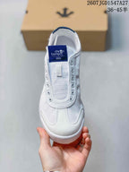 Top view of the white sneaker with a blue Cron Tempo tongue label and stitched toe panels.