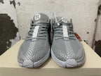 Front view of grey Nike basketball shoes with patterned toes, grey laces, and white outsole details.