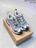 Pair of Salomon XA PRO 3D Seasonal sneakers displayed on a Salomon shoe box, showing the gray, white, lavender and neon yellow colorway.