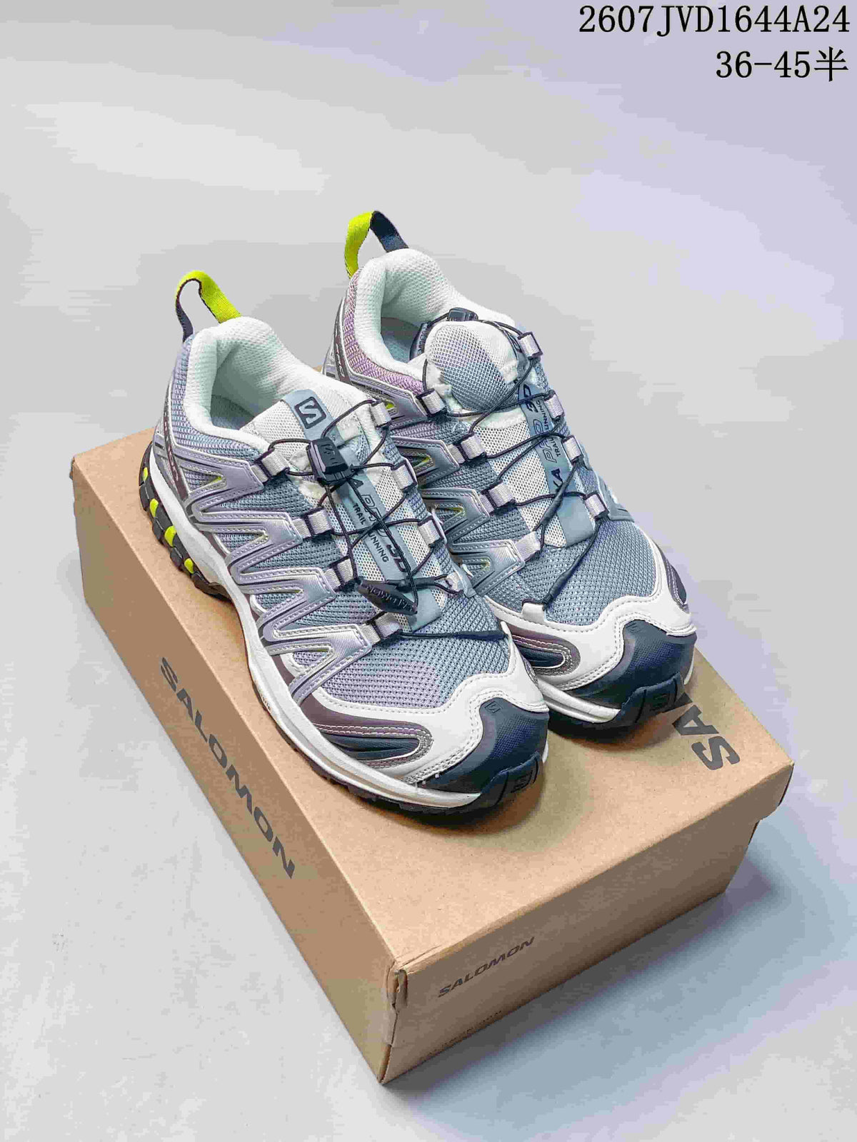 Pair of Salomon XA PRO 3D Seasonal sneakers displayed on a Salomon shoe box, showing the gray, white, lavender and neon yellow colorway.