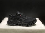 Side profile of a black On Cloudmonster 3 sneaker with visible side branding and segmented outsole.