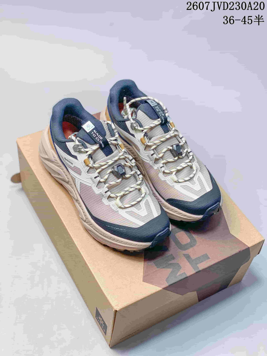 Pair of KAILAS low-top hiking shoes in gray, navy, white, and gold, displayed on a shoebox; image text shows 2607JVD230A20 and 36–45.5.