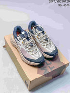 Pair of KAILAS low-top hiking shoes in gray, navy, white, and gold, displayed on a shoebox; image text shows 2607JVD230A20 and 36–45.5.
