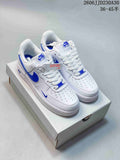 Pair of white low-top sneakers with blue accents on a shoe box