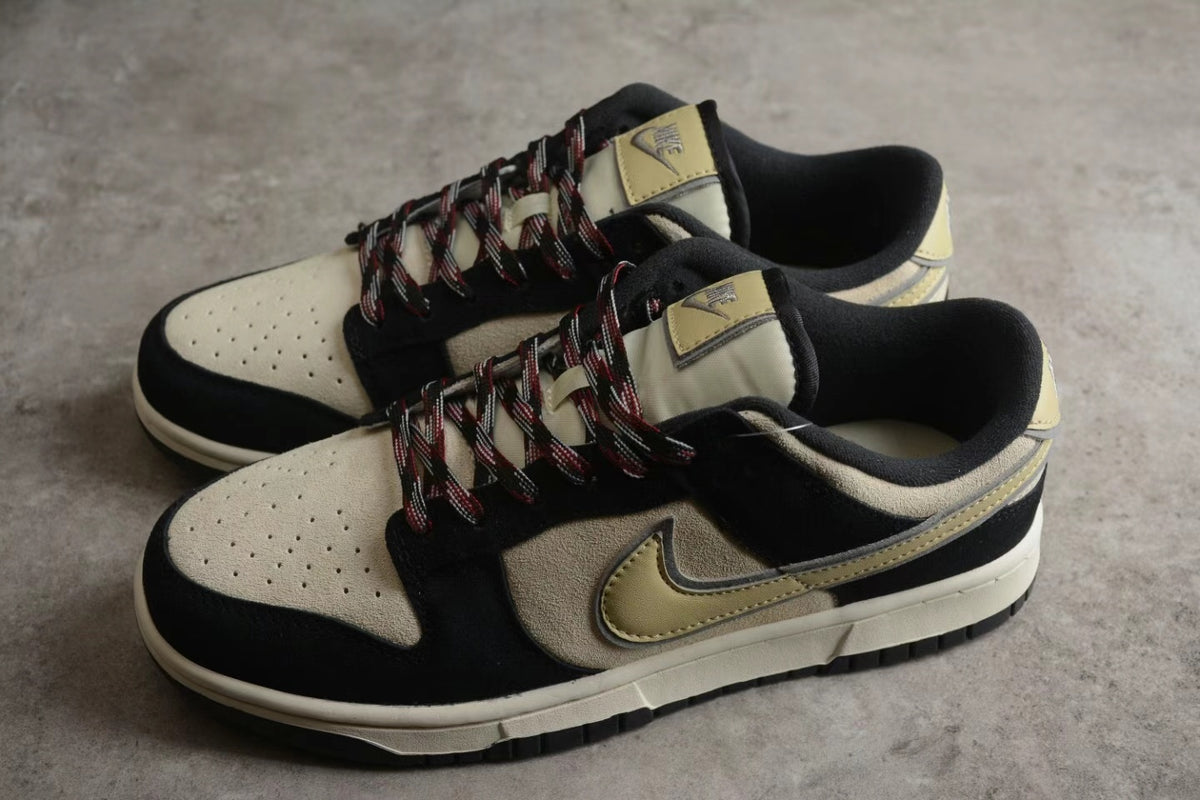 Pair of beige and black low-top sneakers shown from an angled side view.
