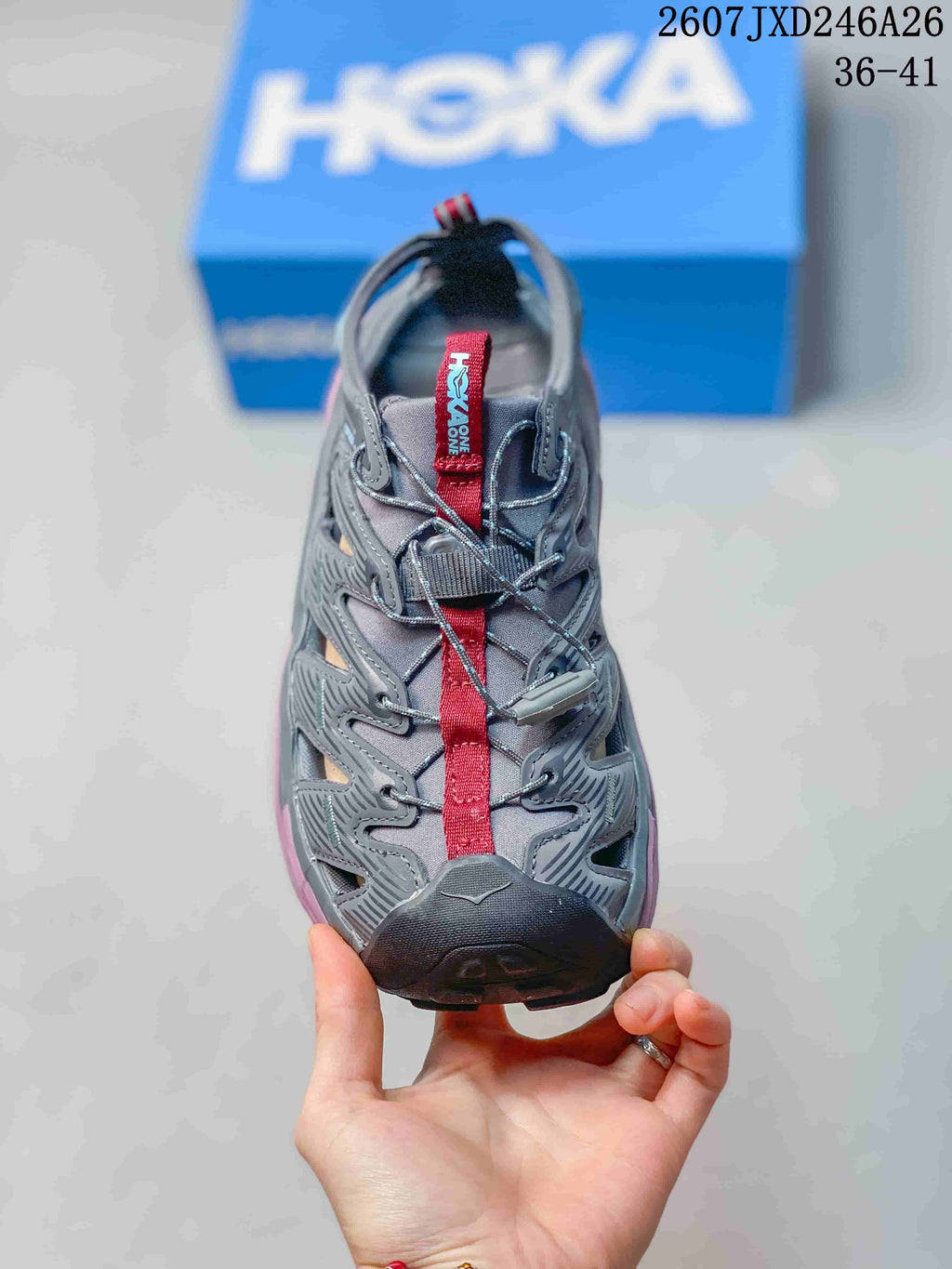 Top view showing the gray upper, red tongue strap and adjustable lace system.
