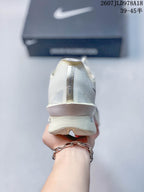 Rear view of the white Nike Vaporfly shoe showing the heel construction and vertical Nike branding.