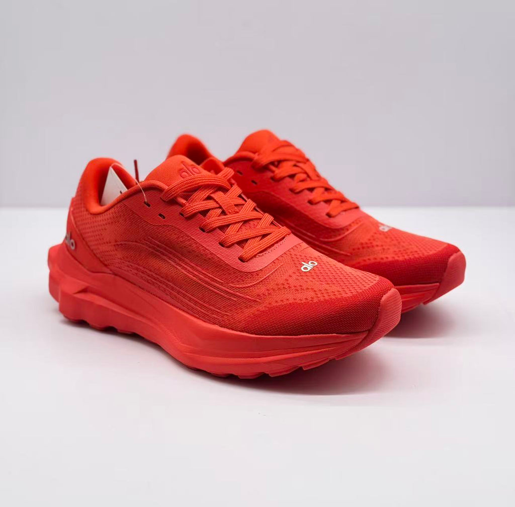 Pair of red alo sneakers shown from a three-quarter front angle.