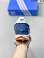 Rear view showing the navy heel, white heel tab, adidas Trefoil branding, and layered sole.