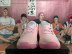 Front view of pink Nike basketball shoes with pink laces and matching toe and outsole accents.