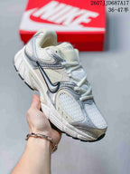 Angled side view of the white and silver low-top sneaker with mesh panels and contrasting overlays.