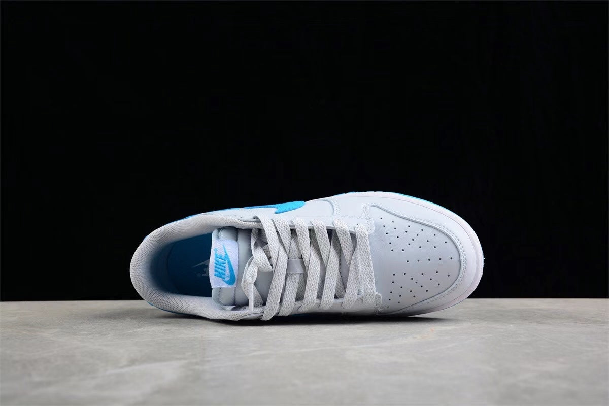 Top-down view of one sneaker showing the perforated toe box, woven laces, padded collar, and blue interior accent.