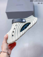 Side view of the off-white clog sandal with a navy adjustable heel strap and textured upper.