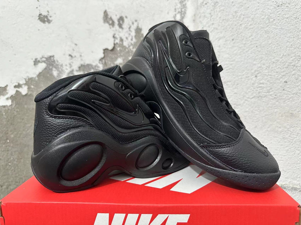 Pair of black Nike sneakers shown at an angle, highlighting the side panels and sculpted soles.