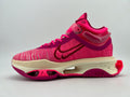 Side view of a pink patterned Nike React sneaker with dark magenta accents, cream-colored midsole, and magenta outsole.