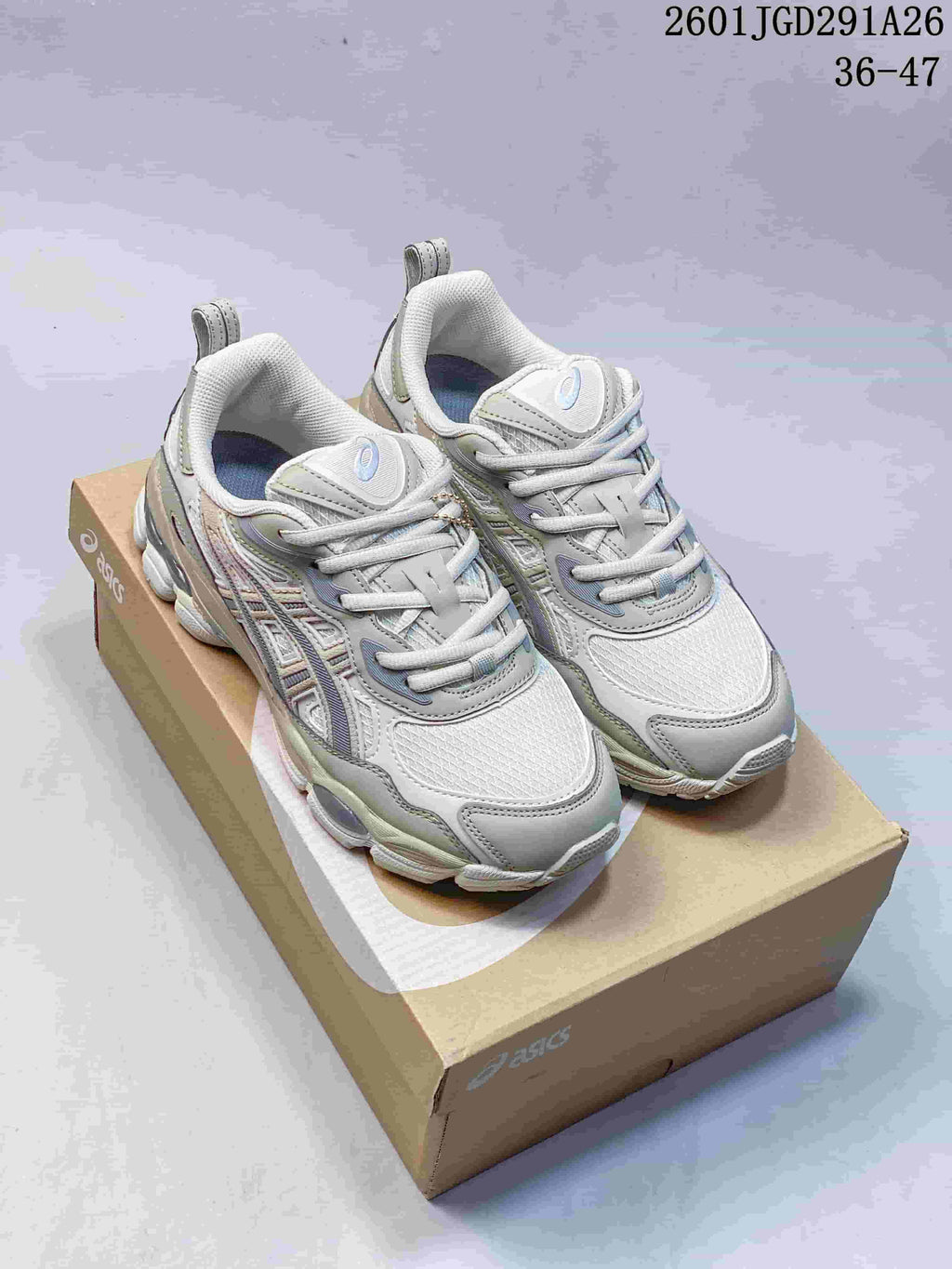 Gray and white ASICS GEL-NYC RGD sneakers displayed on an ASICS shoebox; image text shows 36–47.