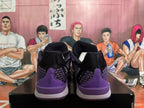 Rear view of black and purple Nike basketball shoes with patterned panels and purple heel details.