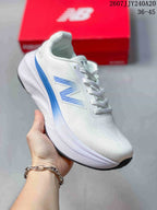 White New Balance running sneaker with blue side branding, a blue heel accent, and a white midsole.