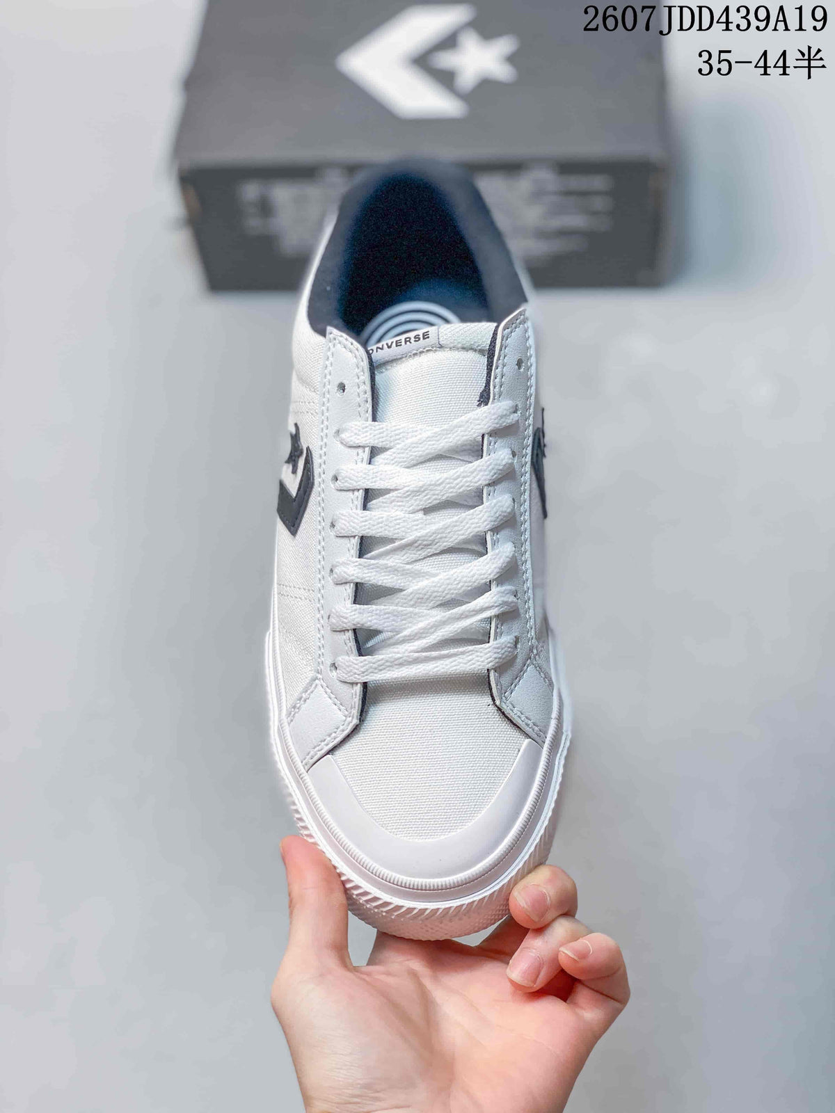 Top view of the white lace-up sneaker showing the rounded toe and dark padded collar.