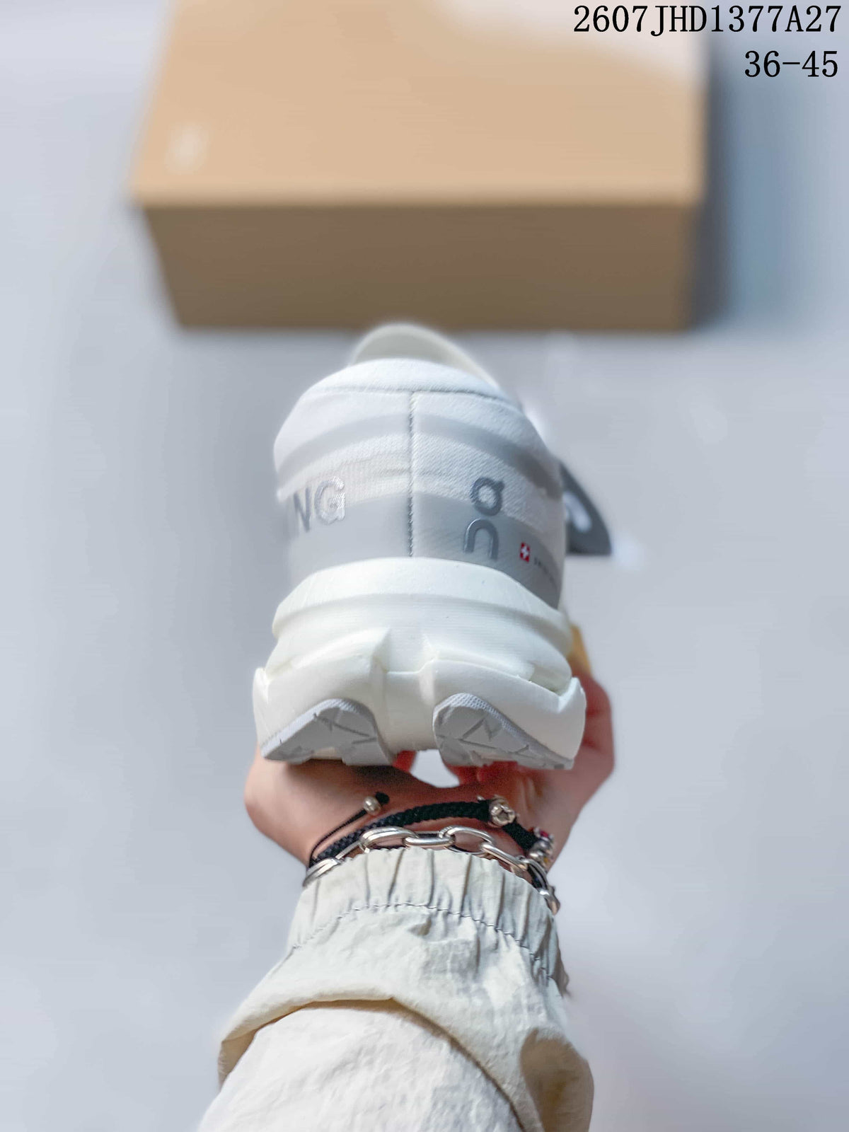 Rear view of a white On sneaker showing the padded heel, white outsole sections, and yellow midsole accent.
