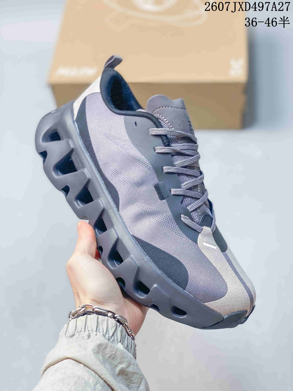Angled side view showing the gray and black upper, white heel panel and sculpted outsole.
