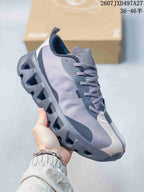 Angled side view showing the gray and black upper, white heel panel and sculpted outsole.