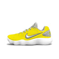 Side view of a low-cut yellow Nike basketball shoe with a silver Swoosh, gray accents, and a white ridged sole