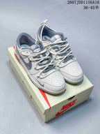 Pair of off-white and gray Nike SB Dunk Low sneakers displayed on a Nike shoe box; image text shows style code 2607JDD1156A16 and size range 36–45.5.